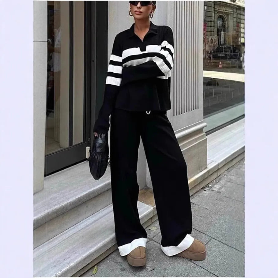 Women's black knitted two-piece set with polo collar top and straight-leg trousers.