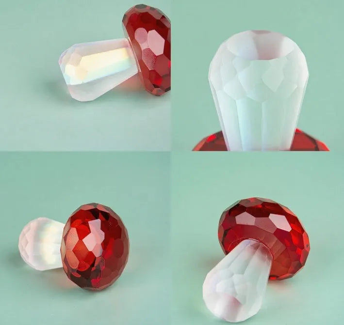 A set of colourful crystal mushroom decorations in transparent, green, red, and yellow on a white surface.