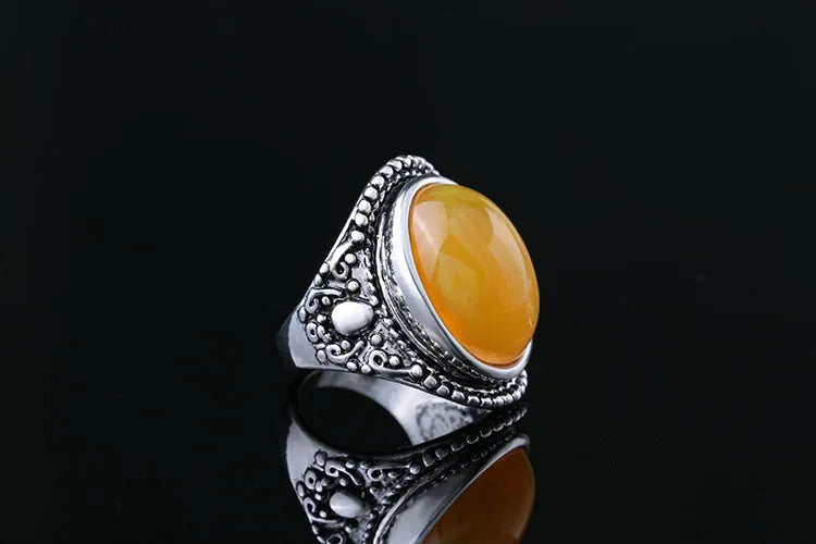 Geometric alloy ring with antique silver and amber electroplated finish shown on a hand.