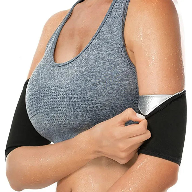 Blue compression arm band with a separate black wrist support strap laid flat.