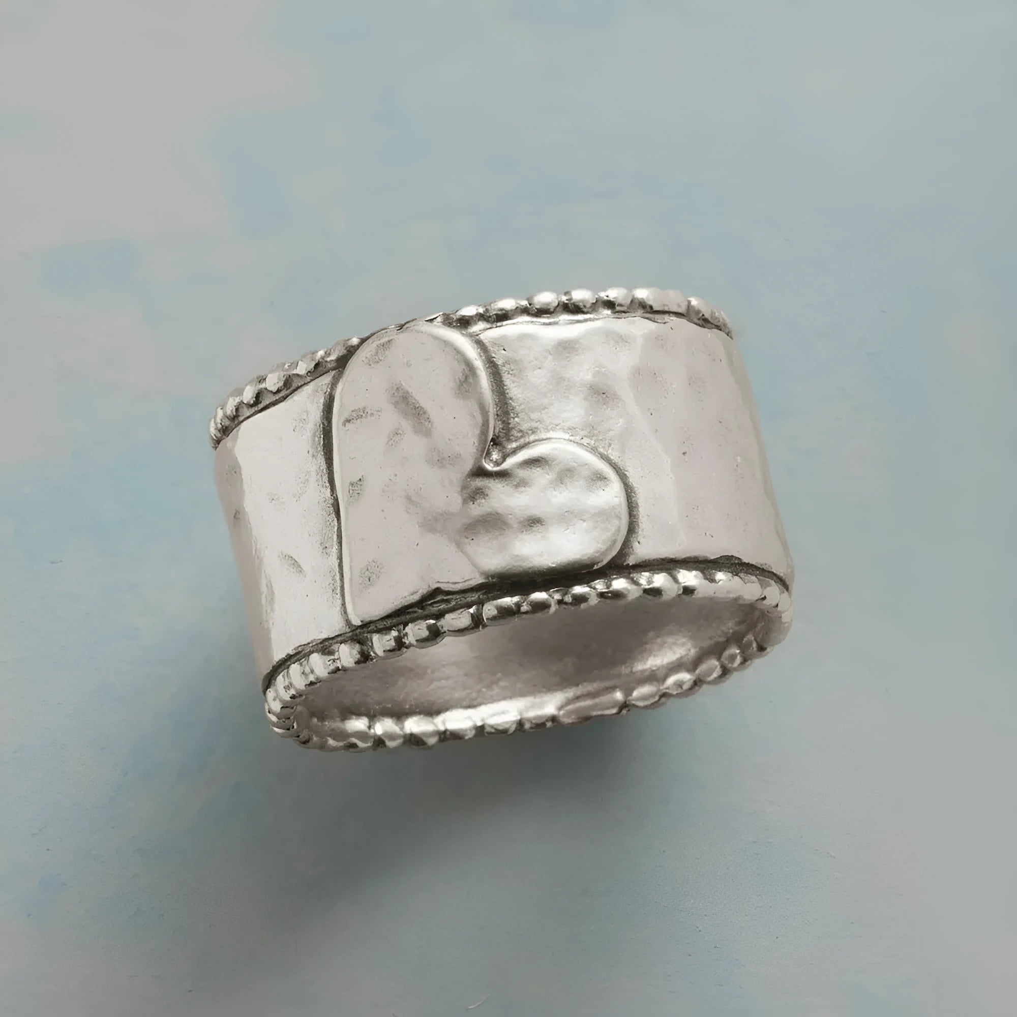 Antique silver heart-shaped hammered ring on finger, zinc alloy, sizes No 7 to 11