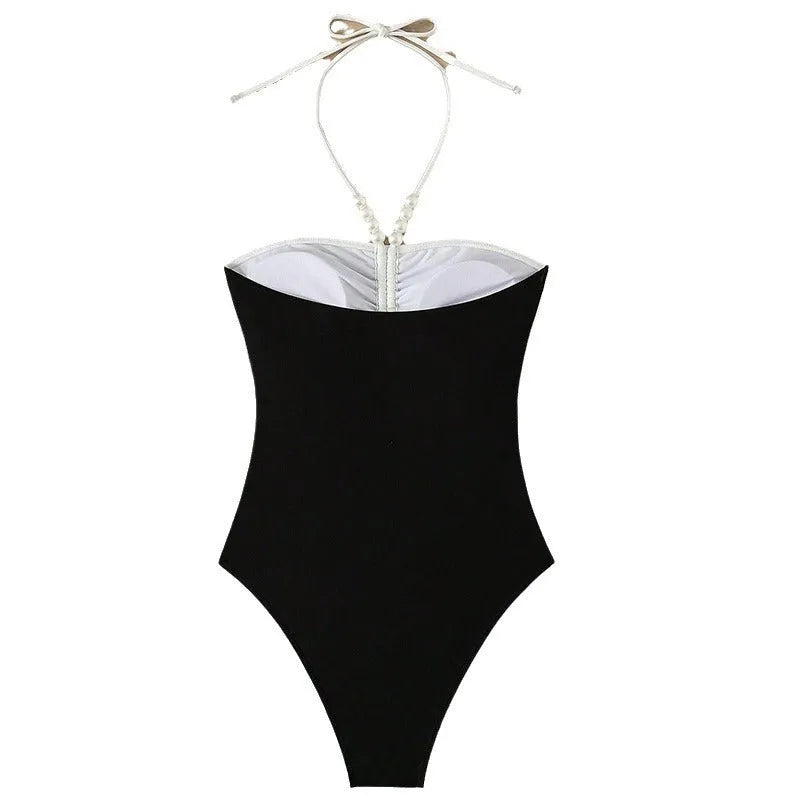 Black and white women's one-piece swimsuit with spaghetti straps and a slimming silhouette