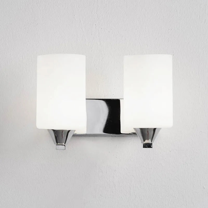 Modern chrome and glass wall lamp with single head design showing glass lampshade and metallic finish