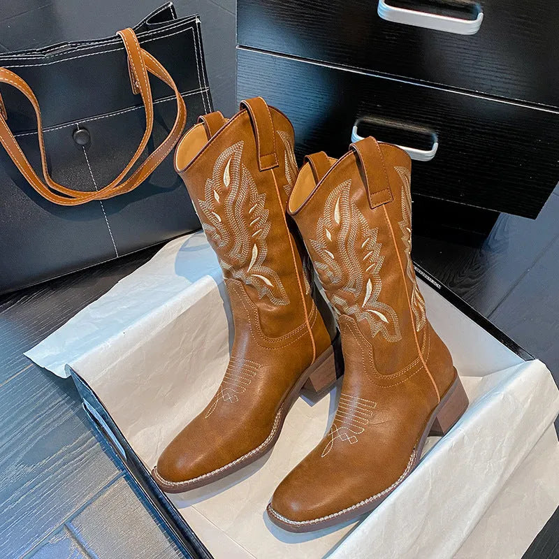 Brown women's Martin boots with embroidered pattern and mid-calf length, showing low square heel and round toe