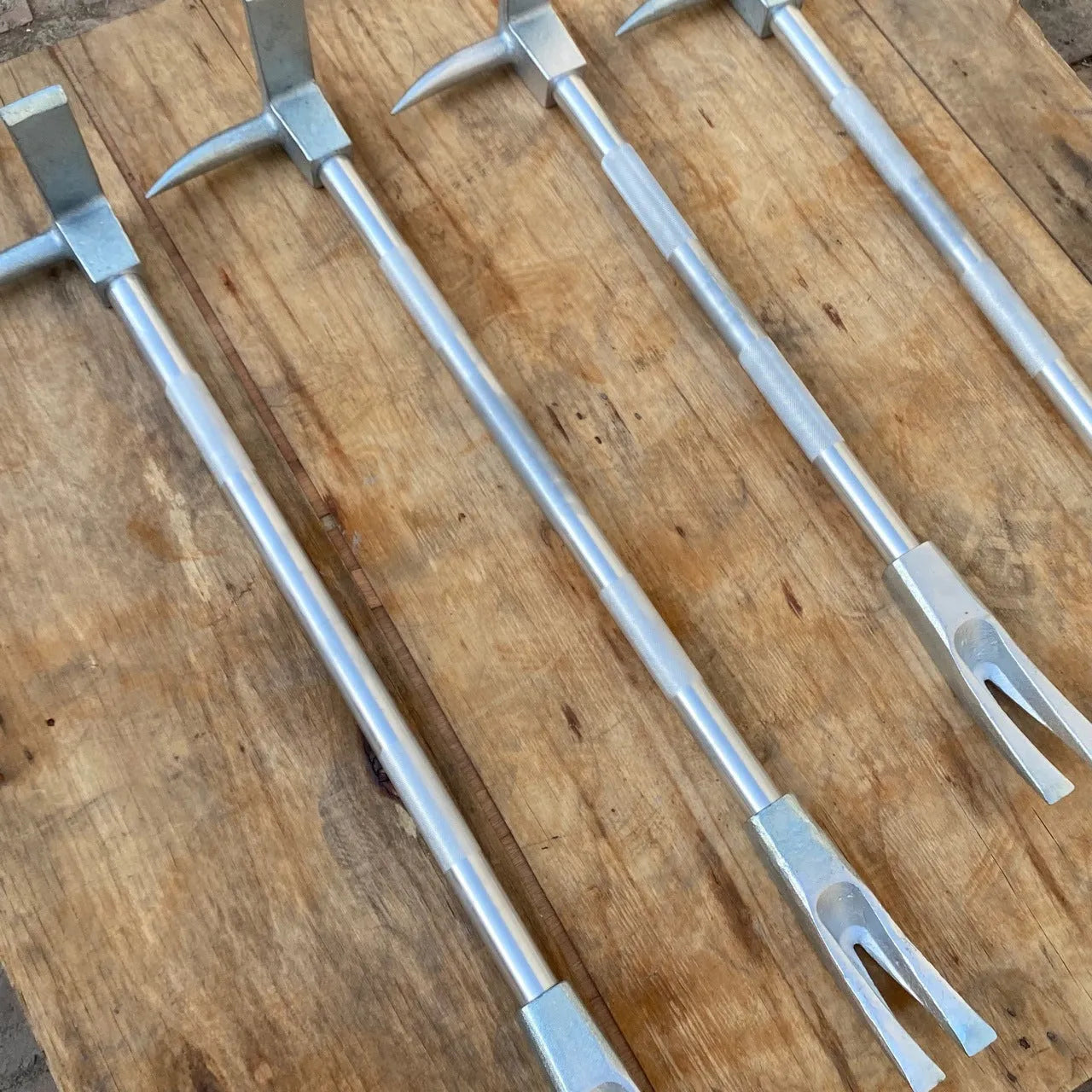 Silver carbon steel wrecking bar 24 inches with iron collar on a dark surface