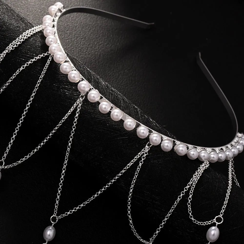 Women's gold mesh hair chain with tassel and pearl decorative elements.