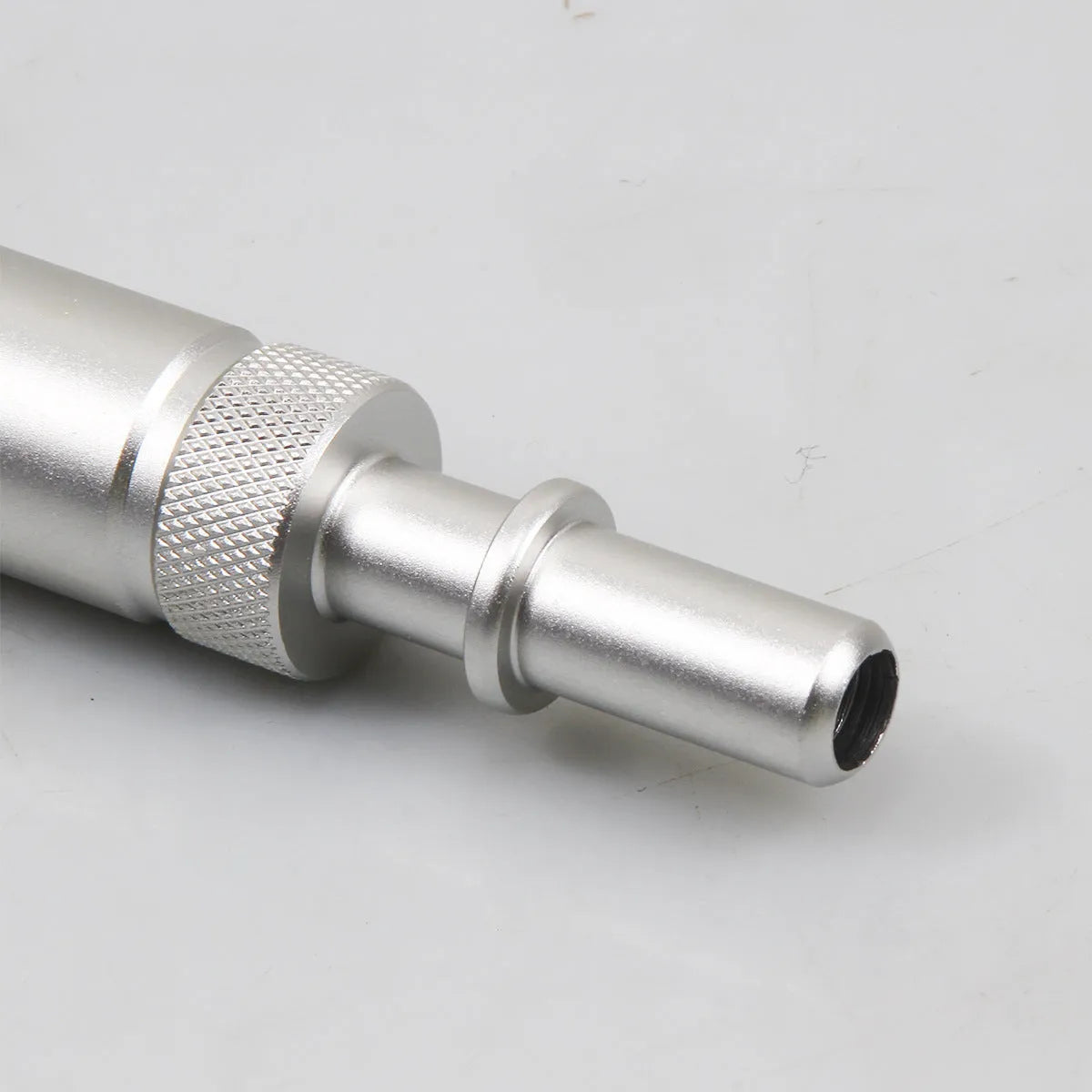 Silver metal transmission refuelling joint for VAS6262-9 tool on a workshop bench.