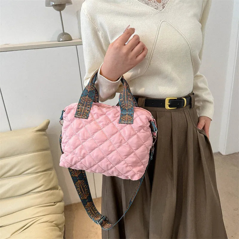 A soft Oxford cloth messenger bag in a horizontal square shape with a single shoulder strap, shown in one of five available colours.