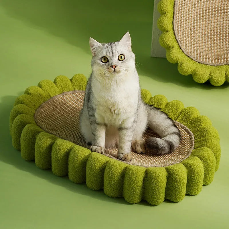 Green oval cat scratcher bed with sisal scratching surface measuring 65x42cm