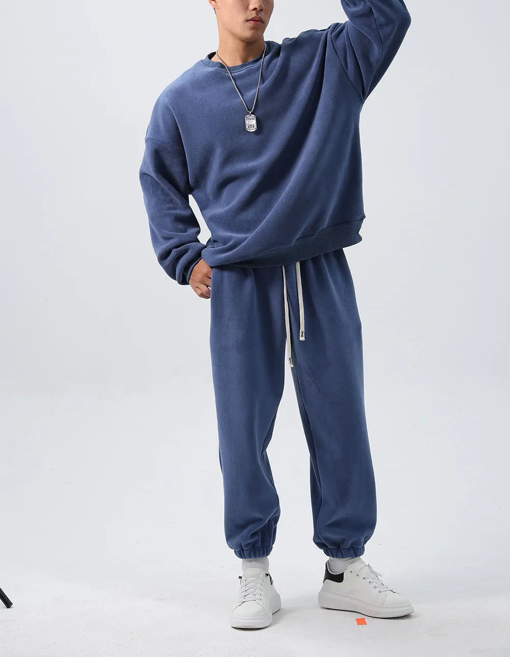 Men's polar fleece tracksuit set showing crew neck top with padded trousers in winter sportswear style