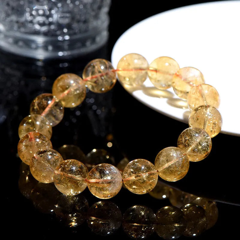 Natural yellow citrine gemstone bracelet showing geometric beads on a string.