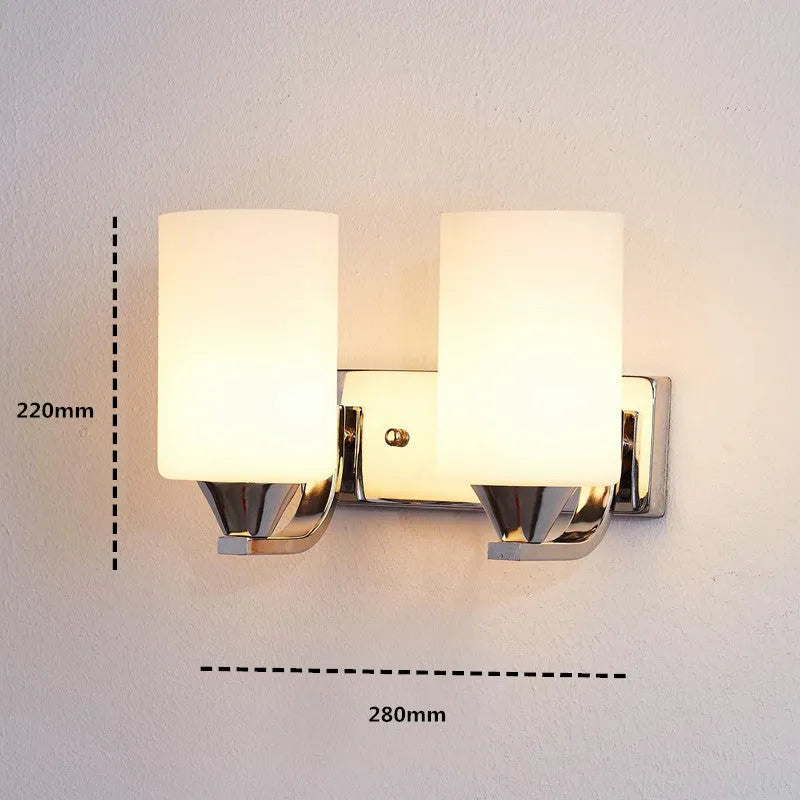 Modern chrome and glass wall lamp with single head design showing glass lampshade and metallic finish