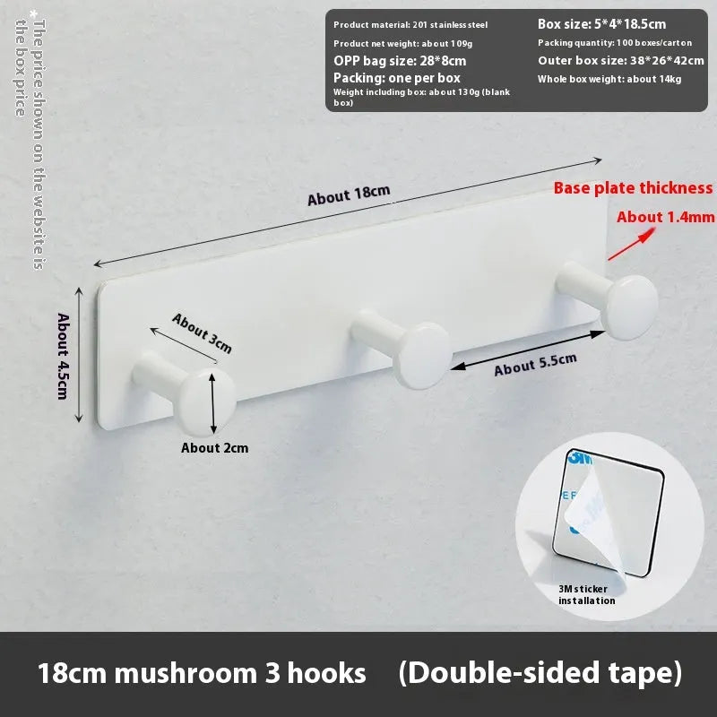 Black and white screwless mushroom-shaped wall hooks in three sizes on a bathroom tile background.