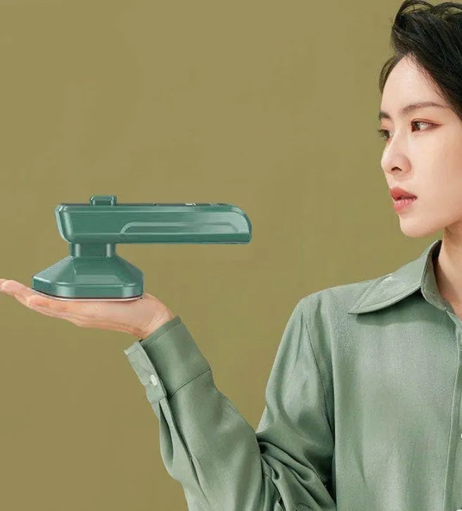 Dark green portable handheld hanging steam ironing machine with ceramic panel and power cord.