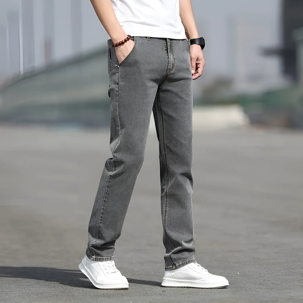 Men's straight-leg smoky gray jeans with low-rise waist and zip fly.