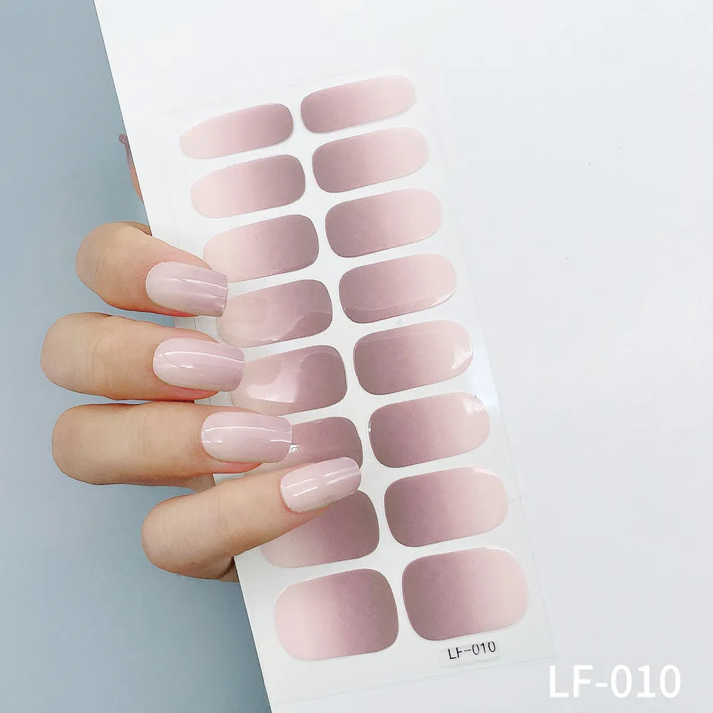 Full sheet of nail art stickers showing sixteen small designs including cross, rose, tulip, and leopard print patterns.