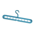 Green plastic folding clothes hanger with nine holes for organising trousers on a rack.