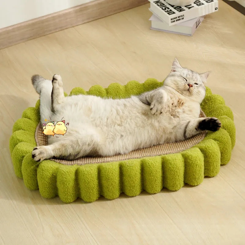Green oval cat scratcher bed with sisal scratching surface measuring 65x42cm