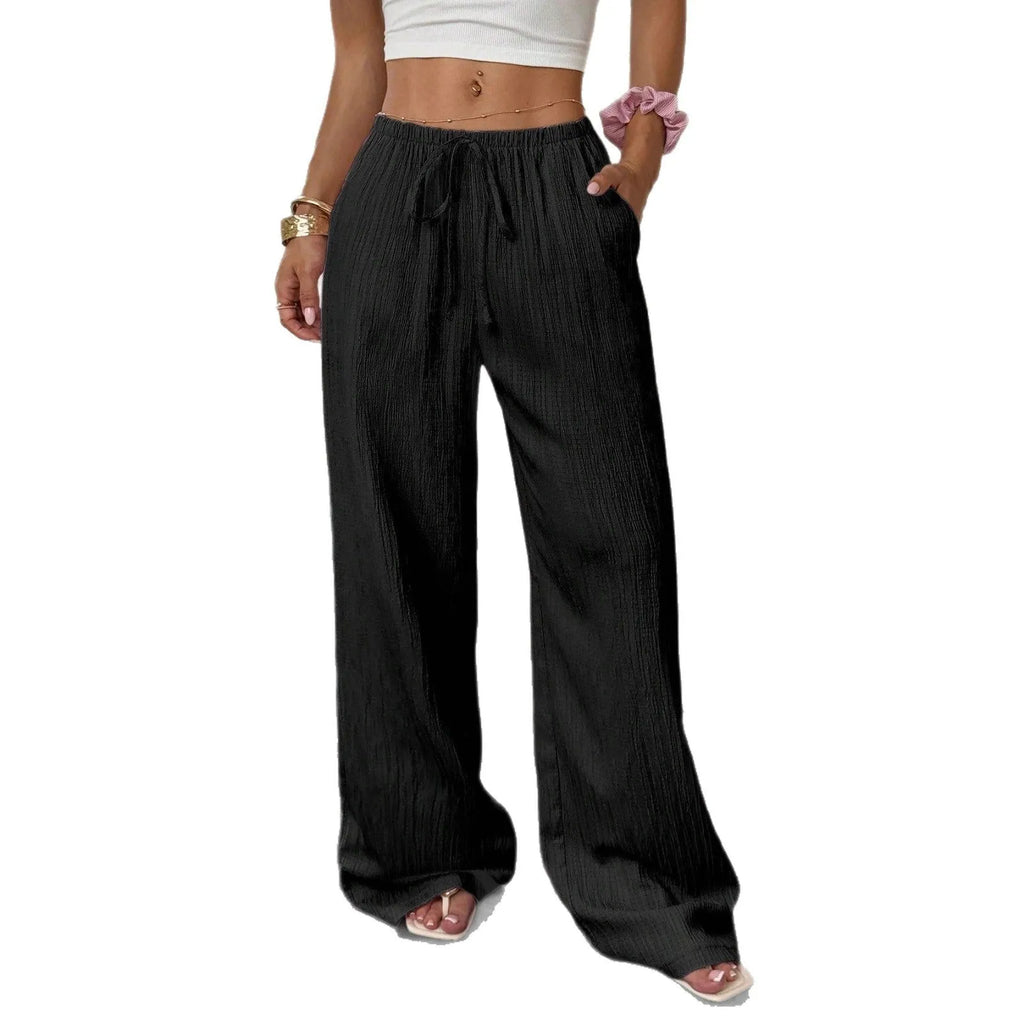 Women's black casual trousers with a lace-up waist detail and wide-leg silhouette.