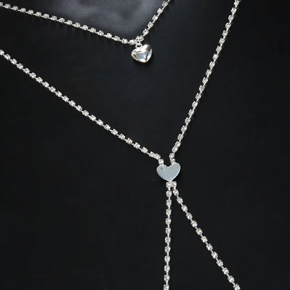 Women's rhinestone body chain with heart shape in gold or silver colour with electroplated finish