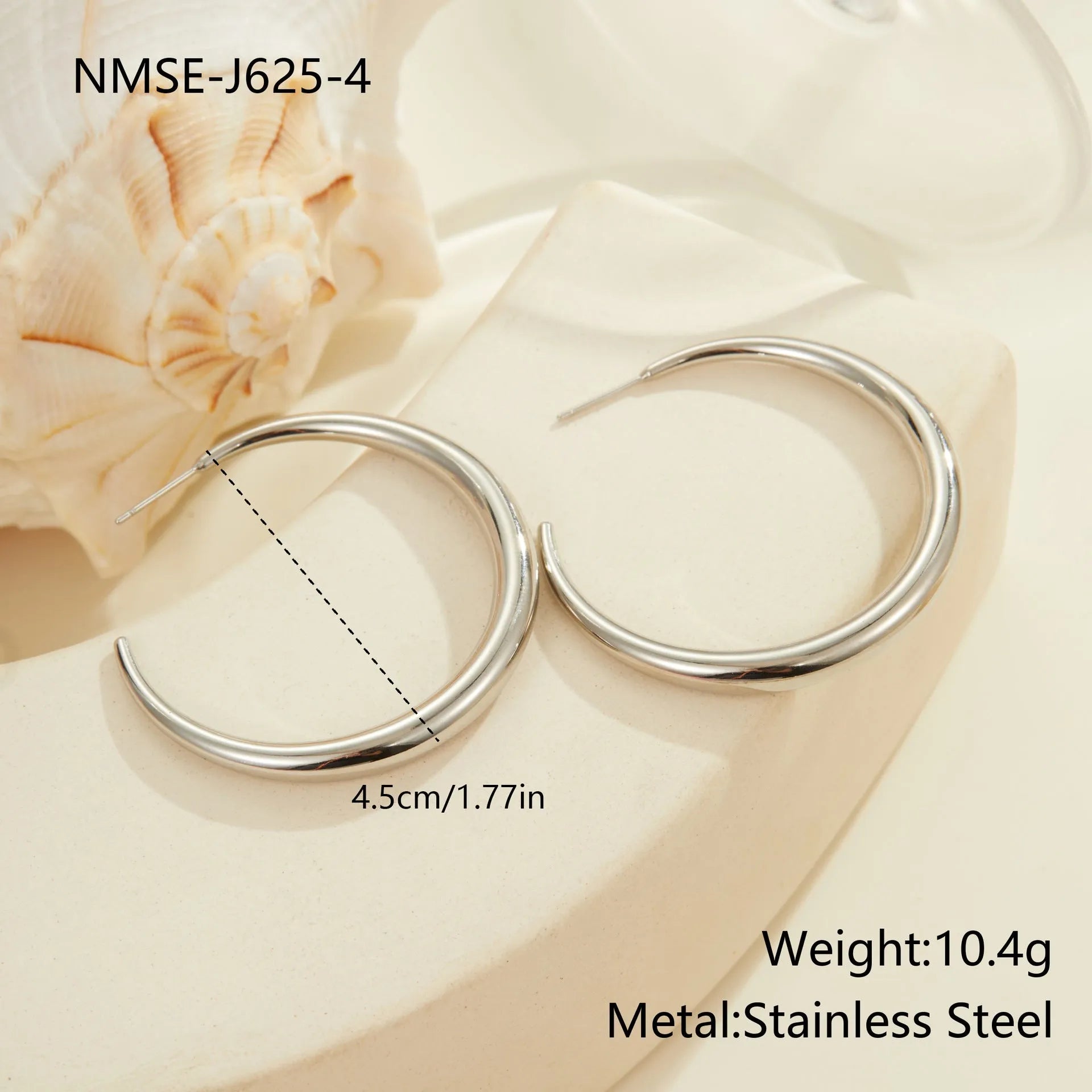 A pair of simple round titanium stainless steel hoop earrings shown in both gold and steel finishes.