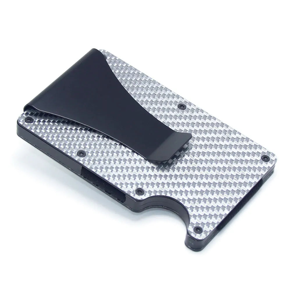 Slim black carbon fibre card holder wallet with geometric design on a table.