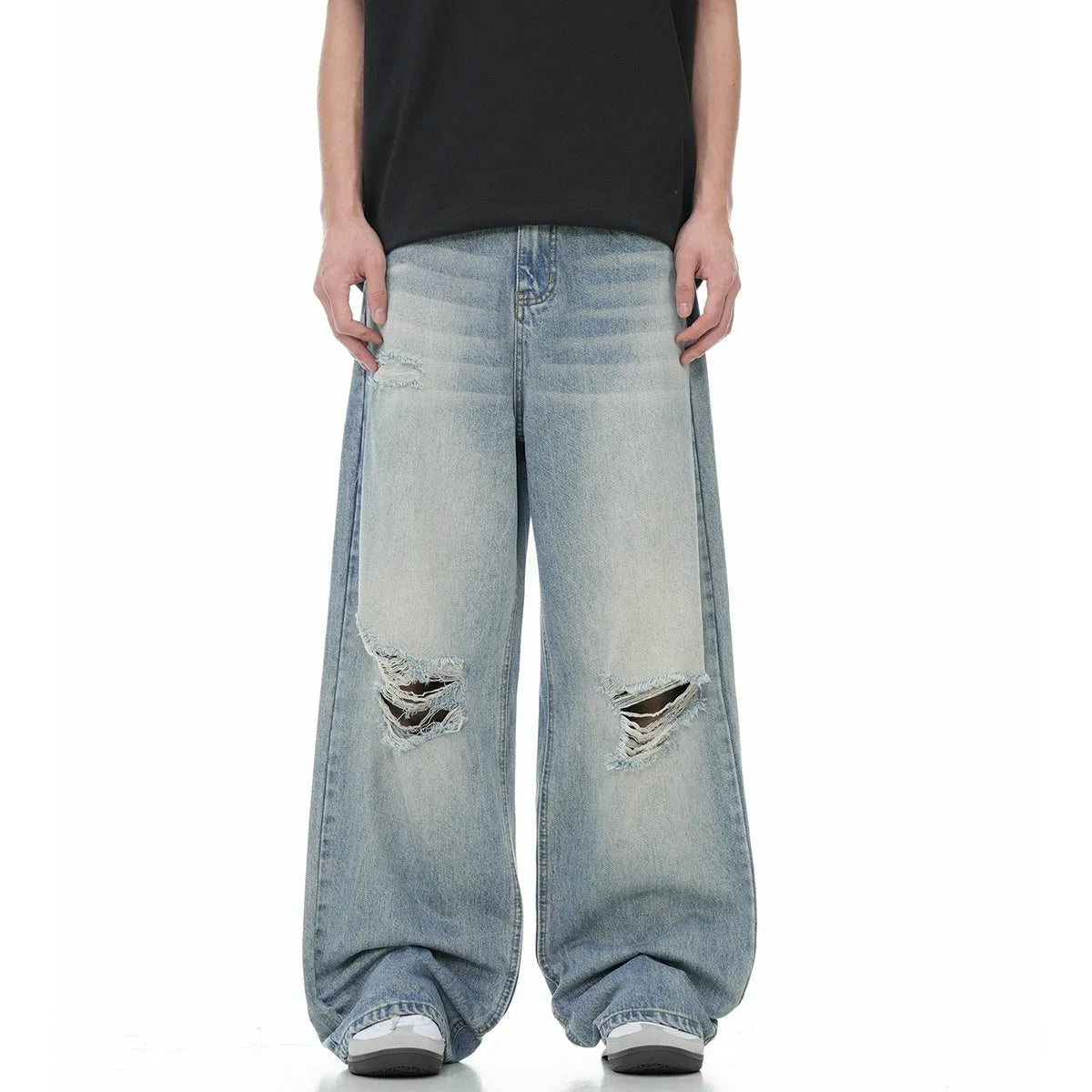 Men's blue straight leg jeans with ripped detailing on a cotton blend fabric.