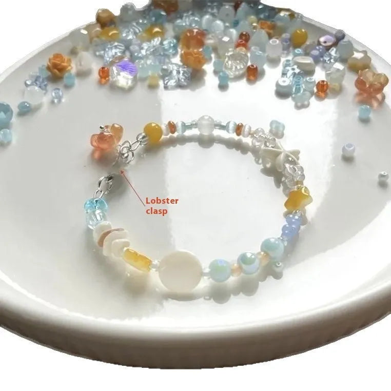 Orange alloy bracelet with diamond shape and round seawater-themed decorative elements