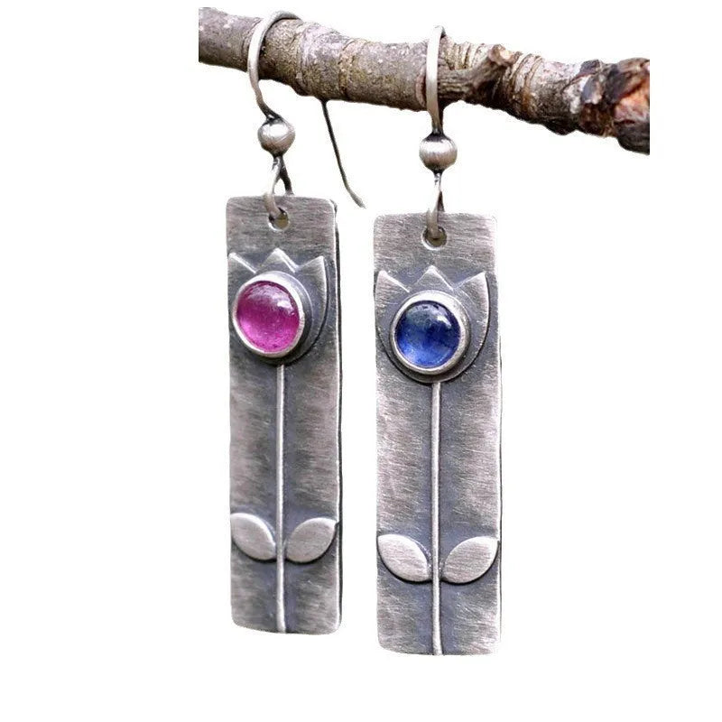 Antique finish gold tone geometric ellipse earrings with red sapphire stone accent