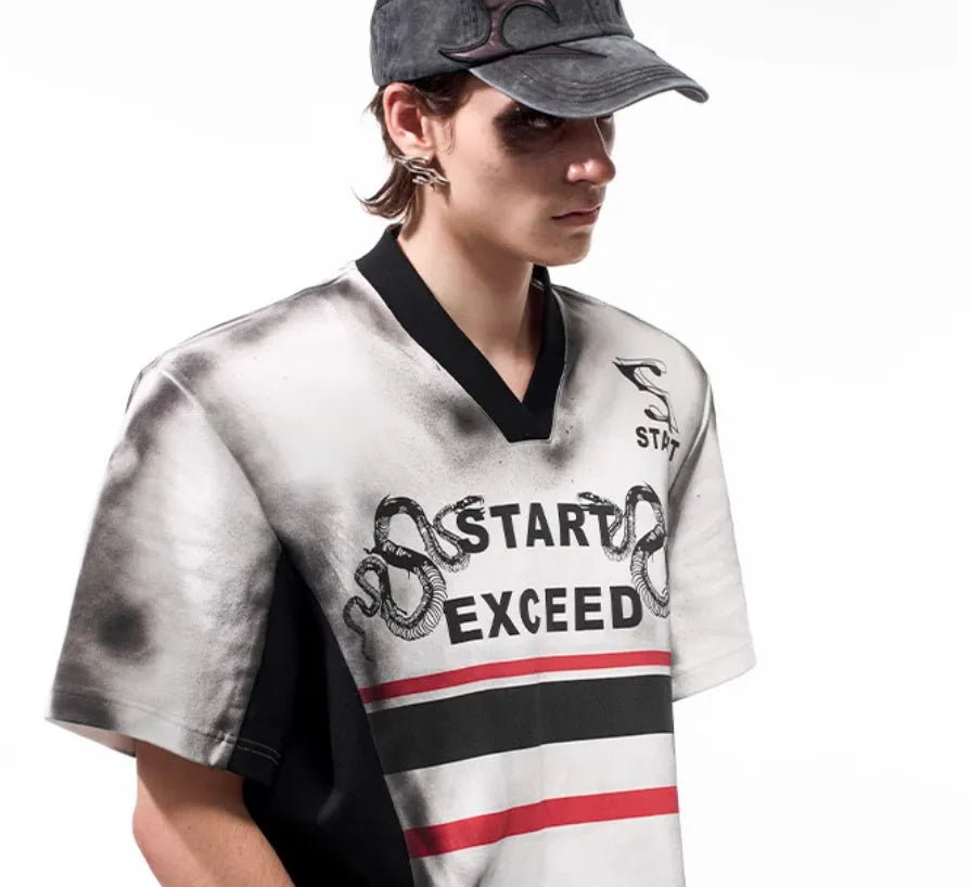 Women's short sleeve V-neck top with a black and white letter snake pattern print and padded shoulders.