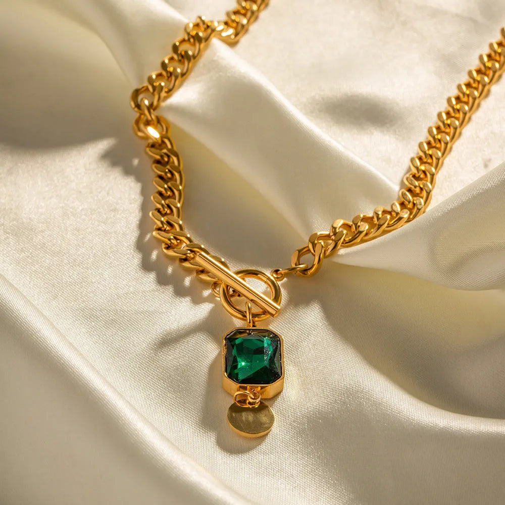 Gold electroplated pendant necklace with geometric round design on Cuban link chain