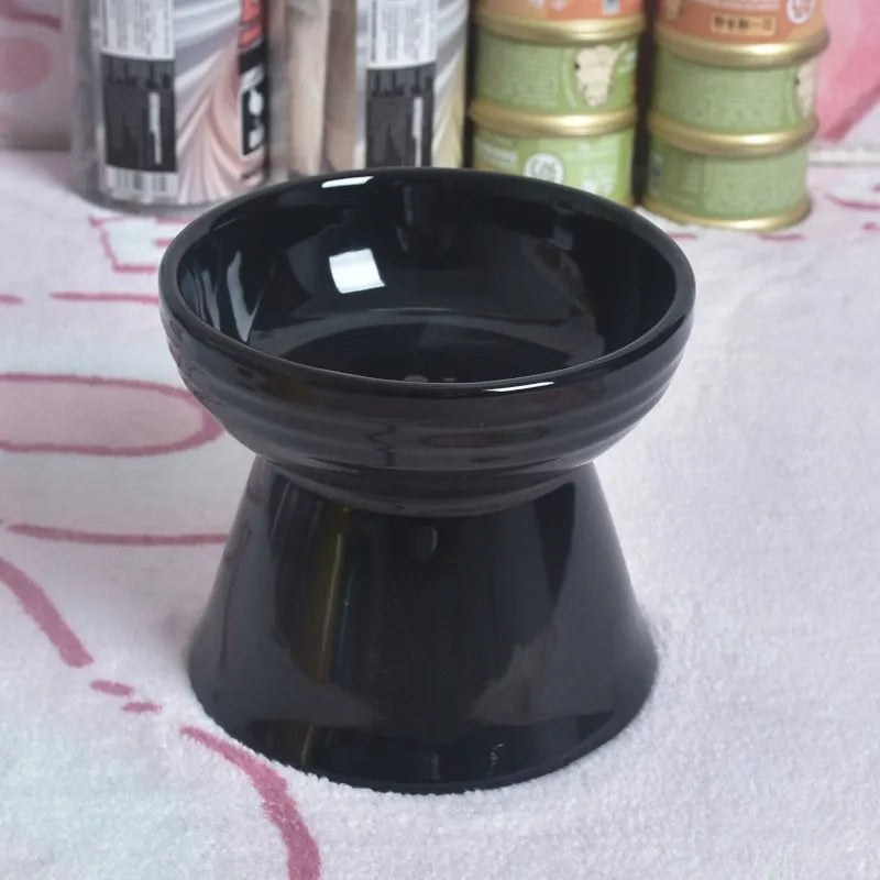 Black chin-high foot ceramic pet bowl for dogs and cats on a flat surface.