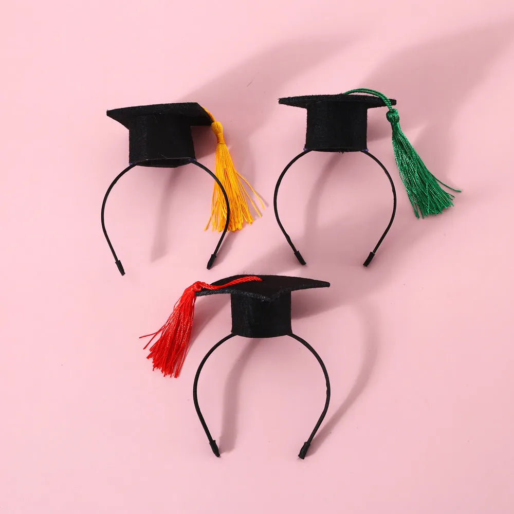 Small pet wearing a woolen felt doctor's degree hair band with a red cap bow tie attached
