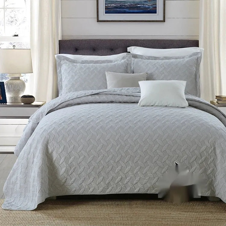 Pure cotton double-sided bed cover three-piece set in a plain colour laid on a bed.