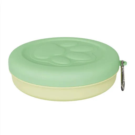 Portable plastic dog bowl for outdoor feeding and water, shown in two-tone green colour.