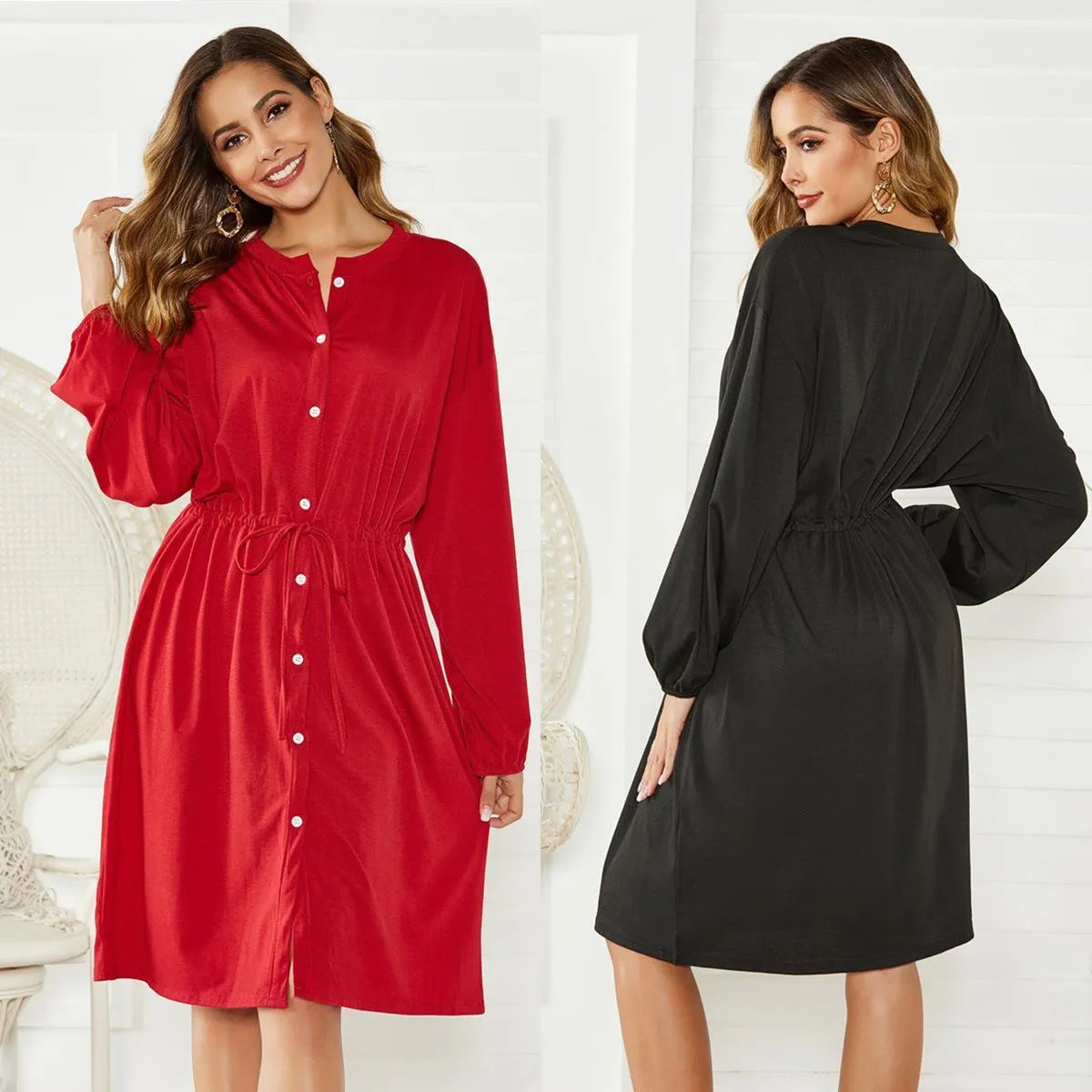 A black A-line midi dress with long sleeves, elasticated cuffs and waist, shown with a belt.