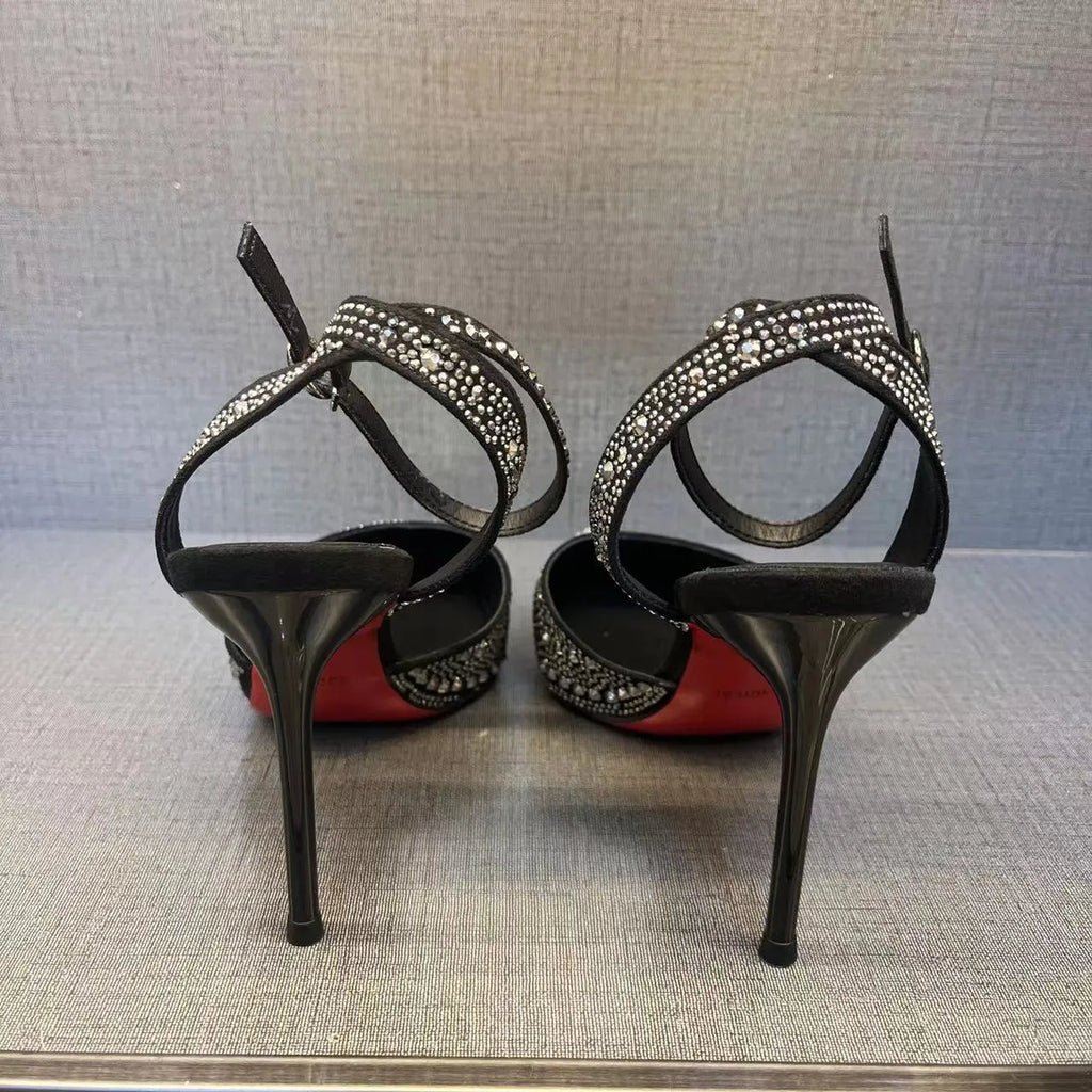 Women's silver high heel shoe with stiletto heel, pointed toe, and red sole on a white background.