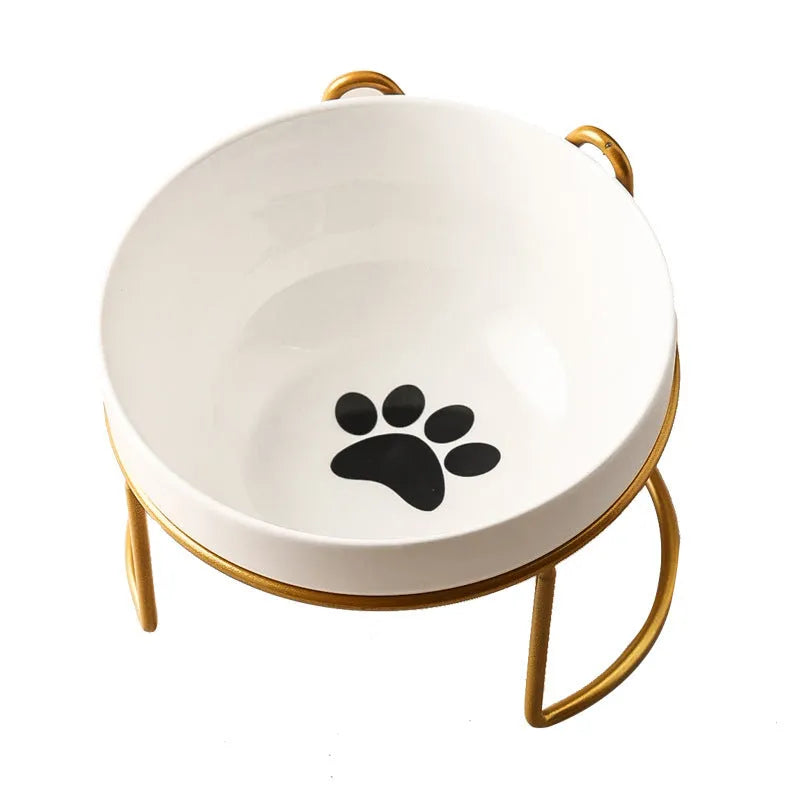 White ceramic pet bowl with cat footprints design in a black iron frame.