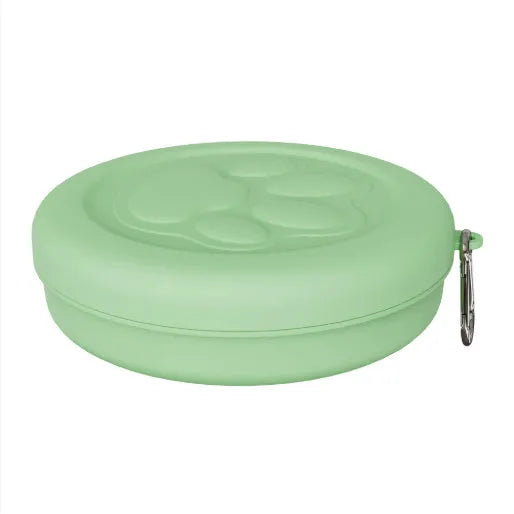 Portable outdoor dog bowl set in light green and pink, showing food bowl, water dish, and snack box compartment.