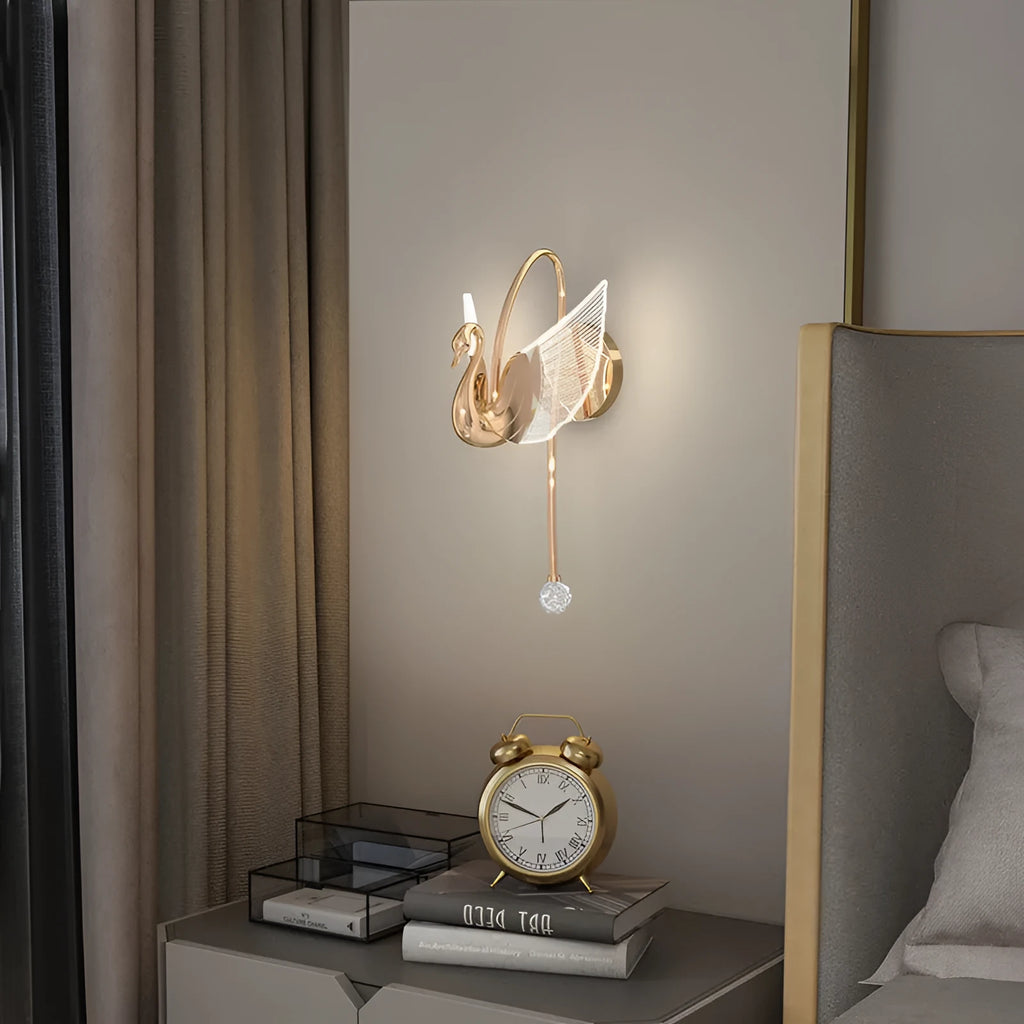 Gold swan-shaped wall lamp with acrylic shade and dimmable LED light.