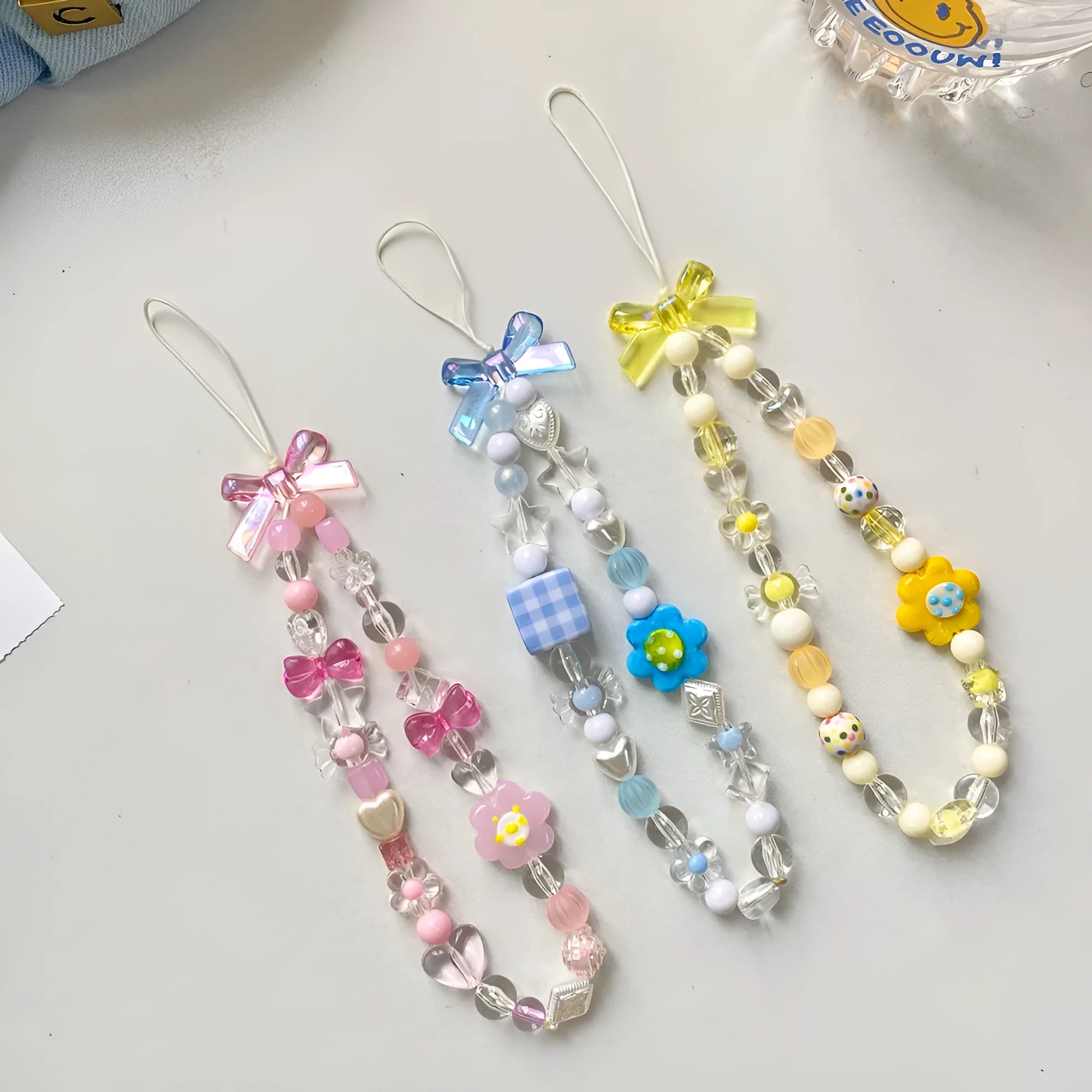Yellow beaded flower mobile phone lanyard with hand rope design on wrist