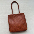 Brown woven tote shoulder bag with three-dimensional pocket made from first layer cowhide leather