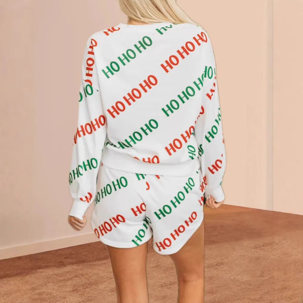 White women's two-piece suit with printed letter design on long-sleeve top and fifth-length trousers.