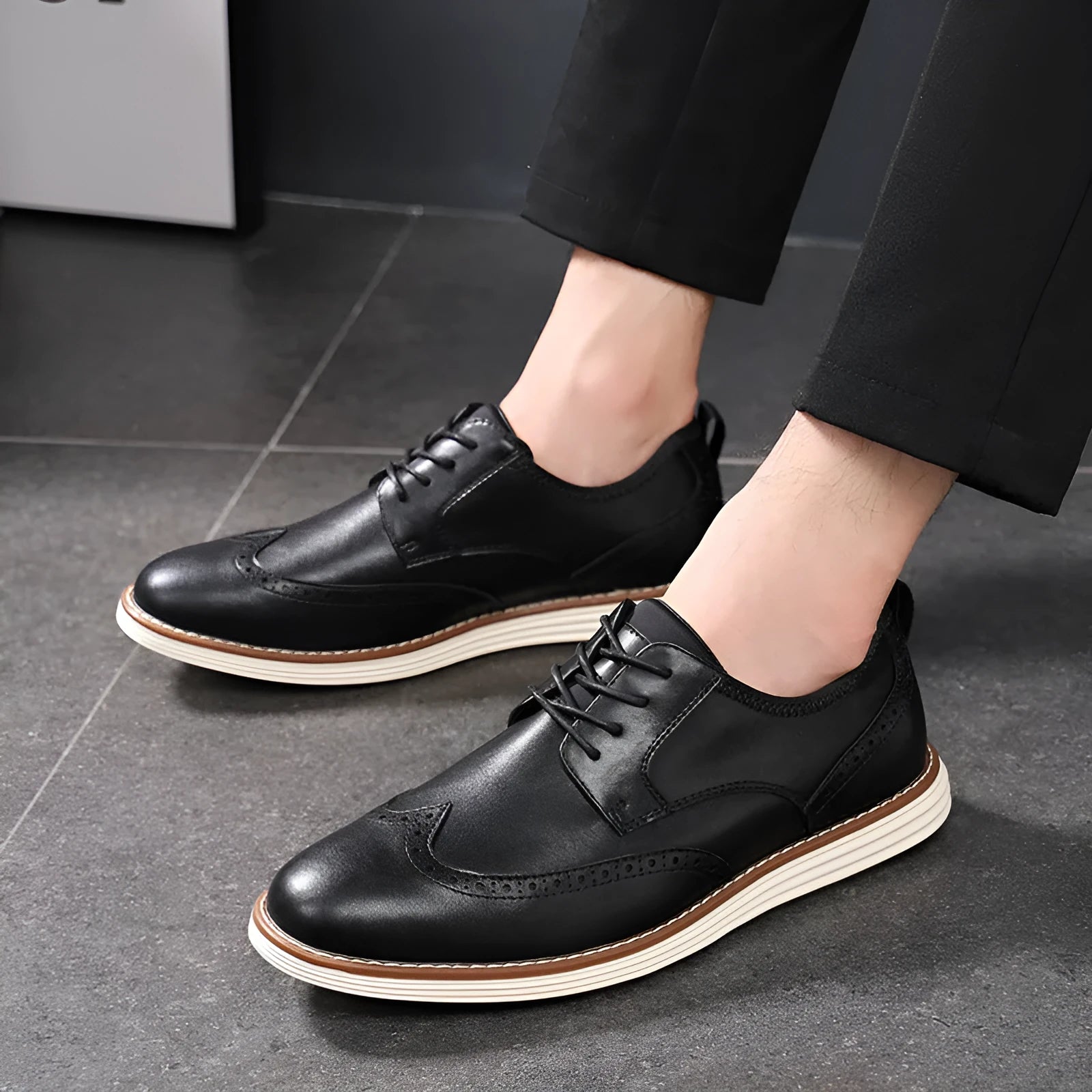 Men's black slip-on business casual shoes with decorative carving details on PU leather upper
