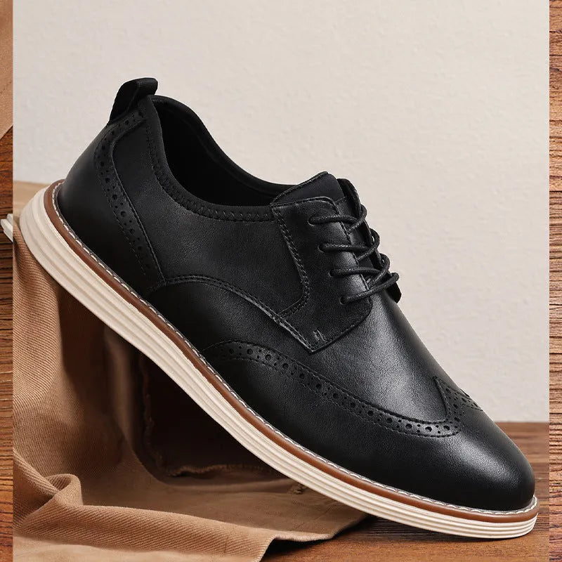 Men's black slip-on business casual shoes with decorative carving details on PU leather upper