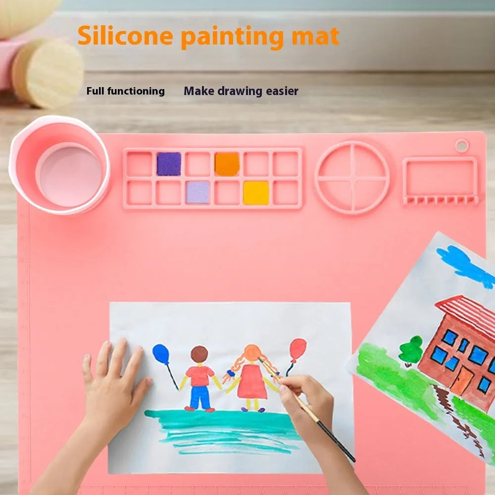 Light blue silicone painting mat with two built-in mixing bowls for graffiti and watercolour art.