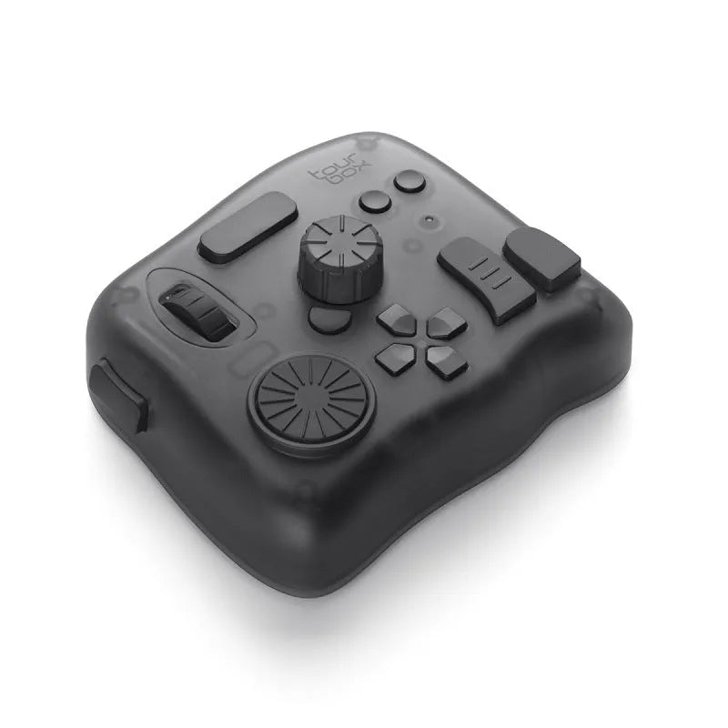 TourBox NEO programmable auxiliary keyboard for video editing and digital creation on a desktop.