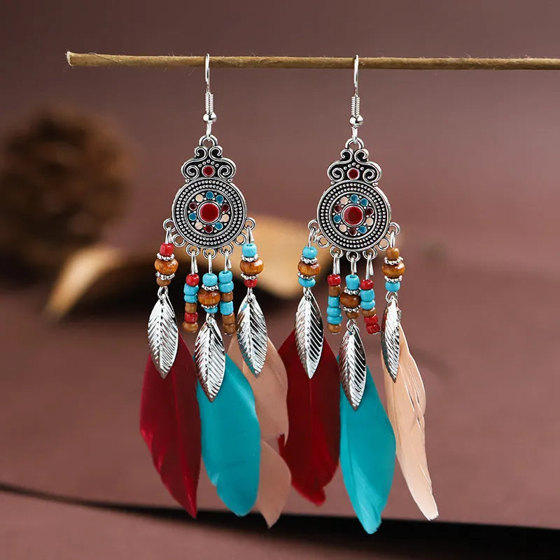 Round drop feather earrings with leaf patterning in alloy, available in multiple electroplated colours.