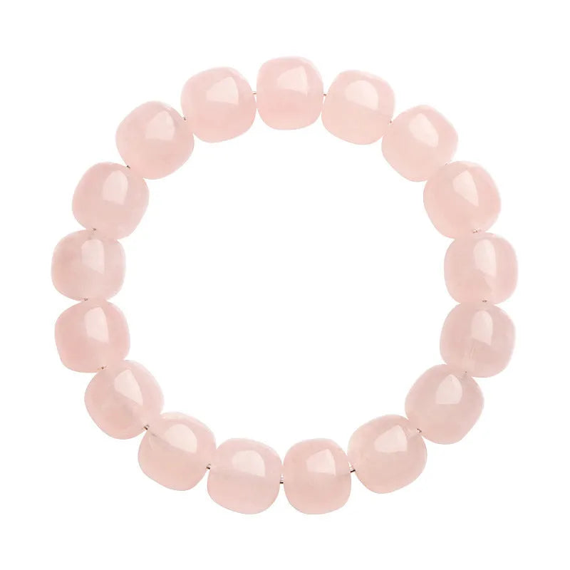 Pink natural bamboo crystal bracelet with 11-12mm geometric barrel beads on a wrist.