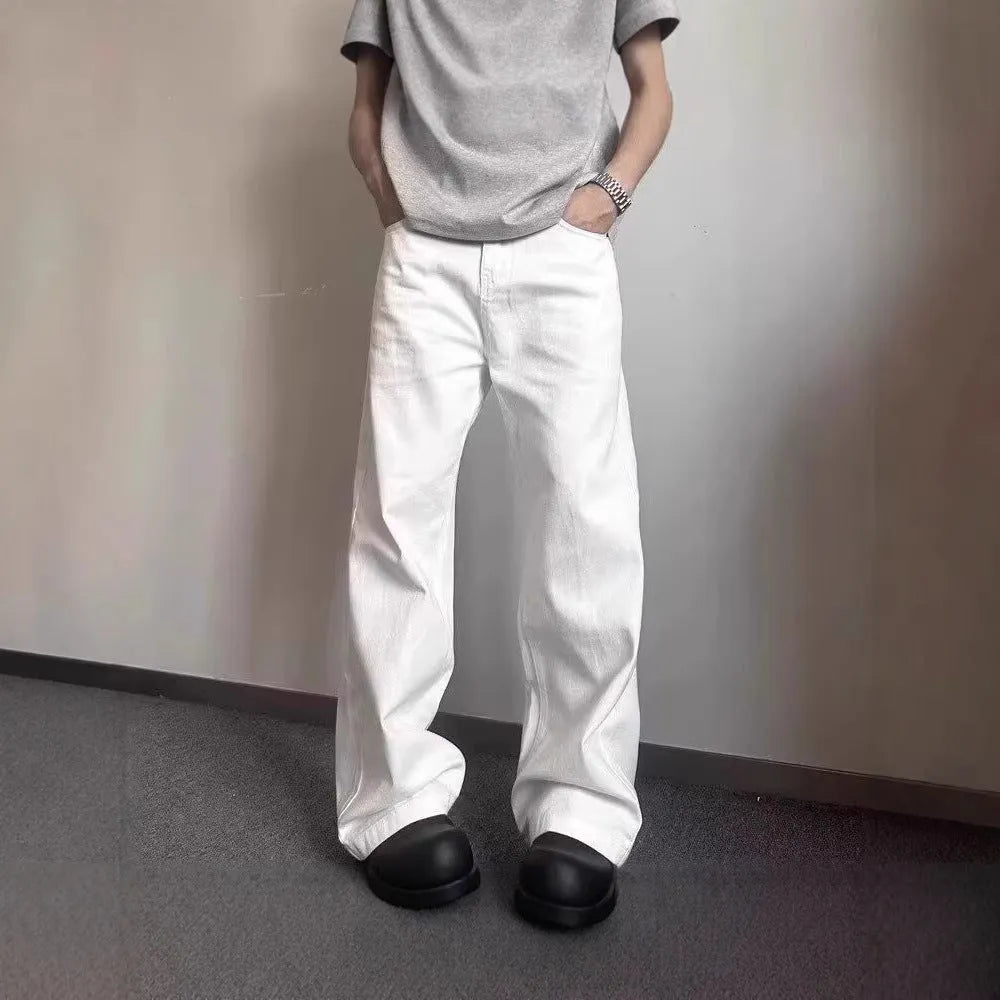 Men's white loose straight-leg jeans with wide leg openings and mid-waist design
